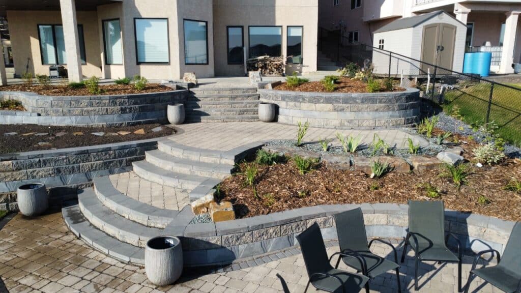 A patio with steps and plants in the middle of it.