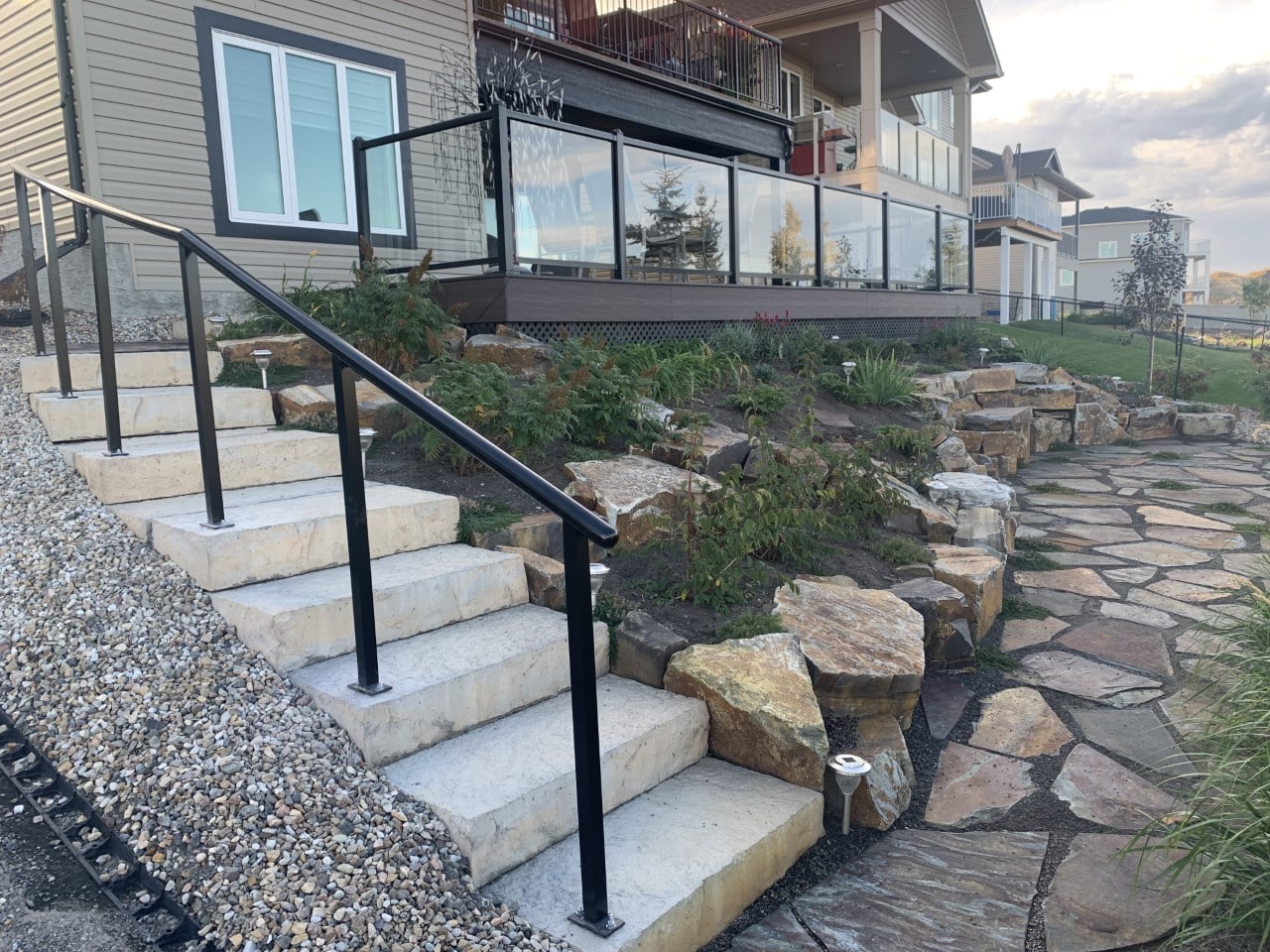 A stone walkway with steps and stairs leading to the house.