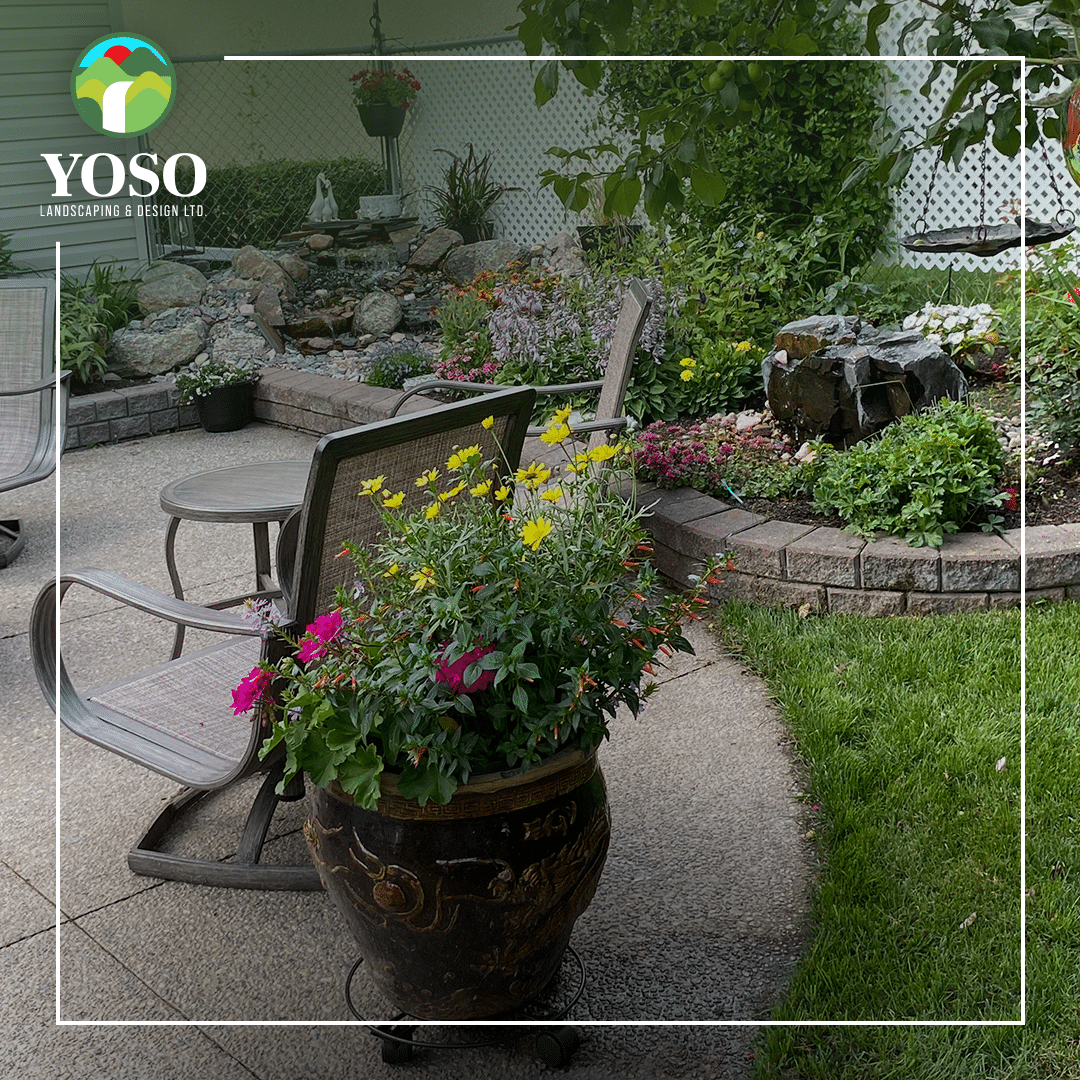 A patio with chairs and flowers in it