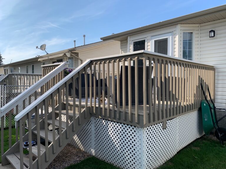 A deck with stairs leading to the back of it.